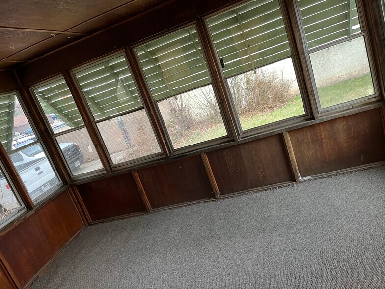 Enclosed porch opens to backyard - 5462 State Rd