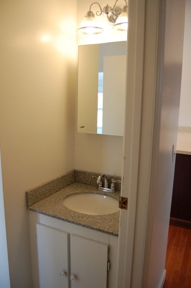Bathroom with marble countertop. - 485 Elmwood Ave