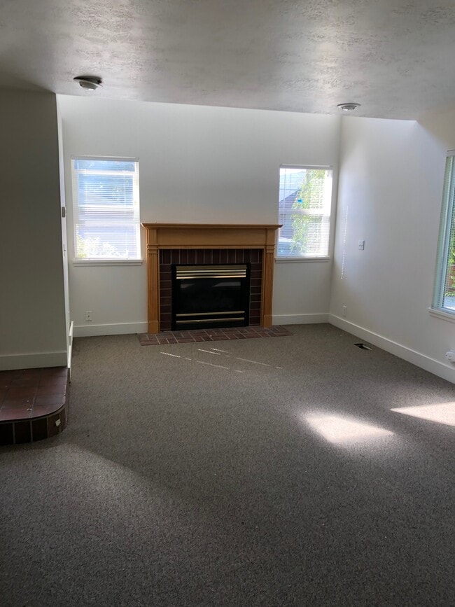 Light filled living room with gas fireplace -new carpet, paint and blinds - 1147 E Garfield Ave