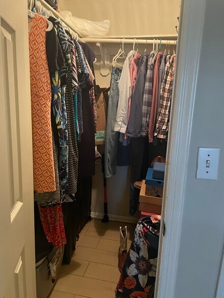 Master walk in closet with clothes to show size. - 2607 Ringold Cir