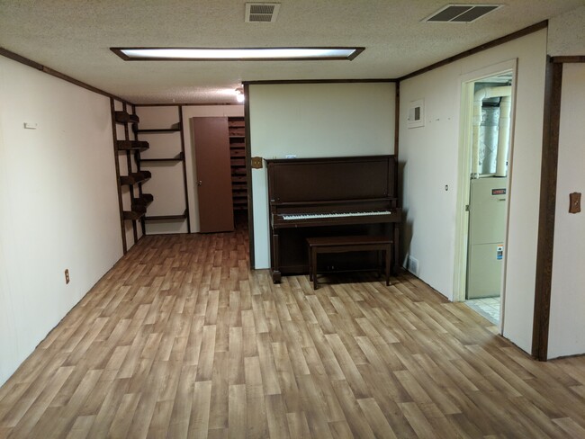 Basement shelves and piano - 28 James Circle