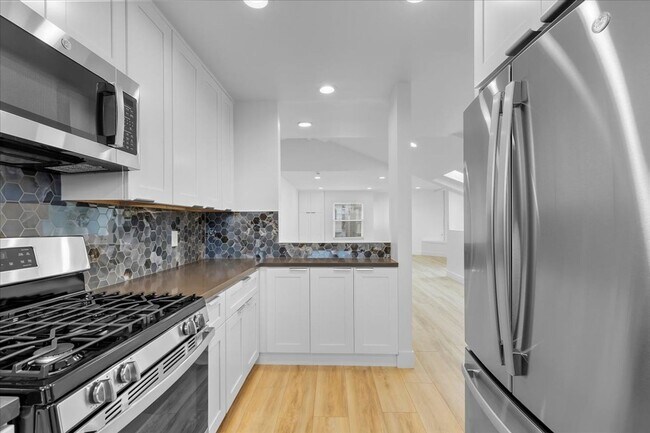 Building Photo - COMPLETELY REMODELED, BRIGHT & AIRY, TRI-LEVEL HOME W/ TOP-FLOOR GREAT ROOM LIVING SPACE, 2-CAR G...