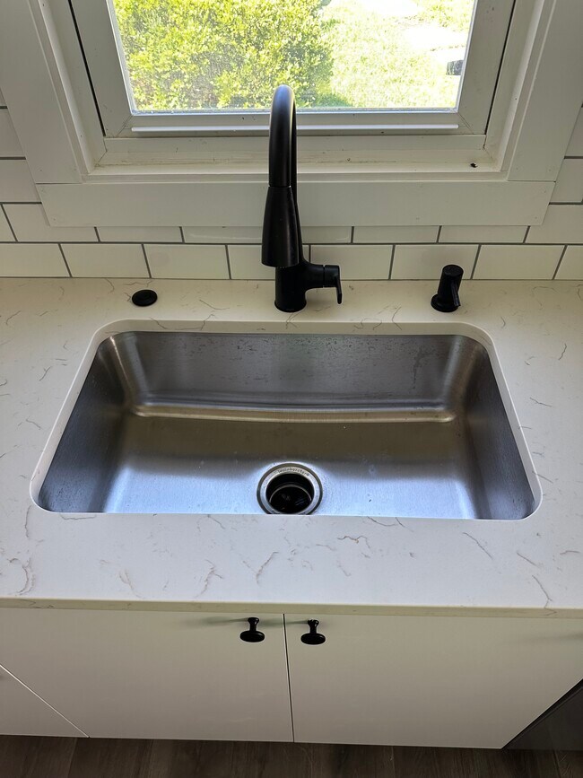 Recessed sink with disposal, air switch, retractable faucet, and soap dispenser. - 240 W 8th Ave