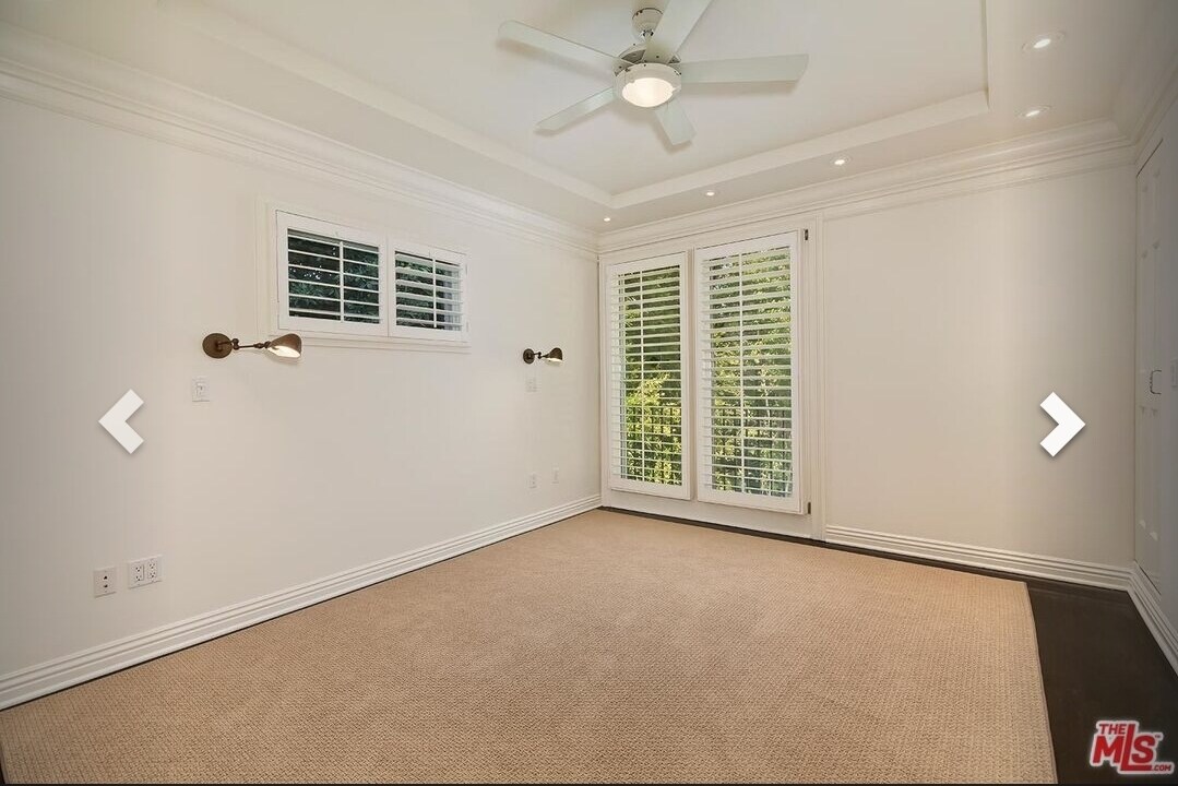 Primary bedroom with reading lights and plantation shutters - 668 S GRETNA GREEN Way
