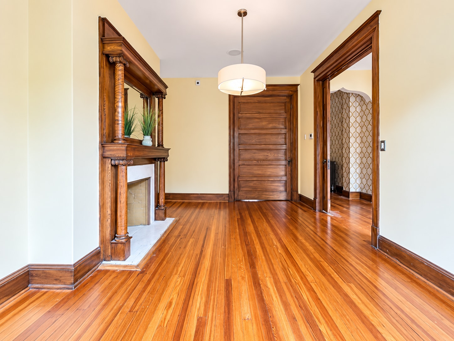 Spacious living room with beautifully preserved fireplace and hardwood floors - 2322 1st St NW