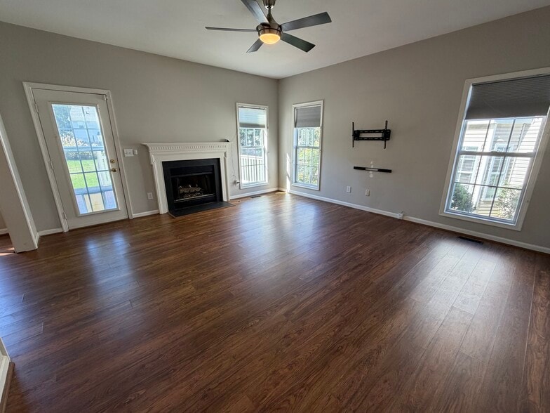 The Den showcases great floor to ceiling windows and a fireplace - 6419 Woodmont Rd