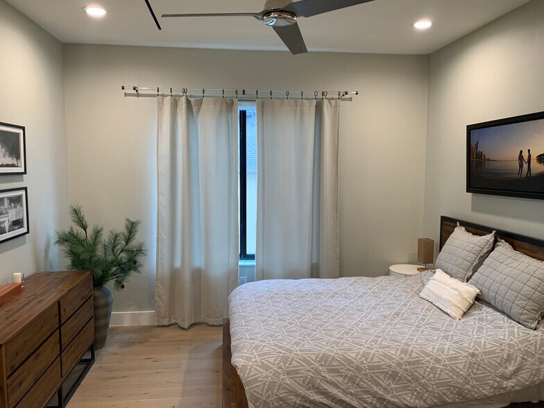 Master bedroom with blackout window treatments and custom drapery - 3923 Cole Ave