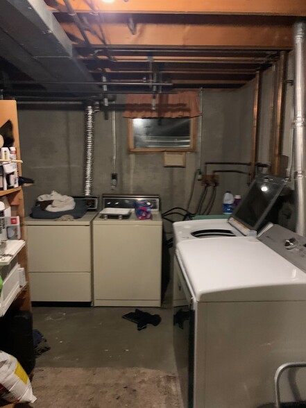 Shared laundry room with dedicated washer and dryer. - 512 29th Ave NE