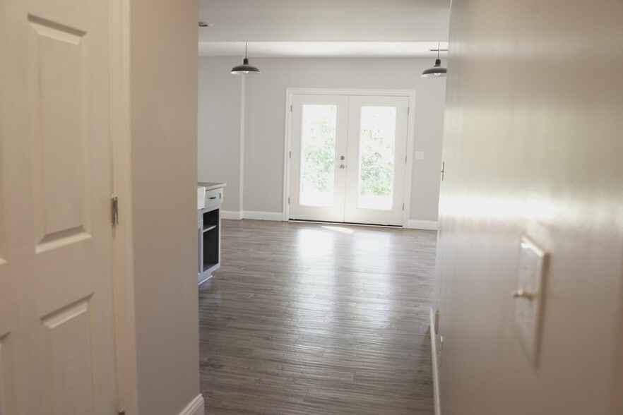 Basement Hallway Entry From Stairs Looking Past Utility Closet (L), Kitchenette & Back Porch Doors - 393 Hays Blvd