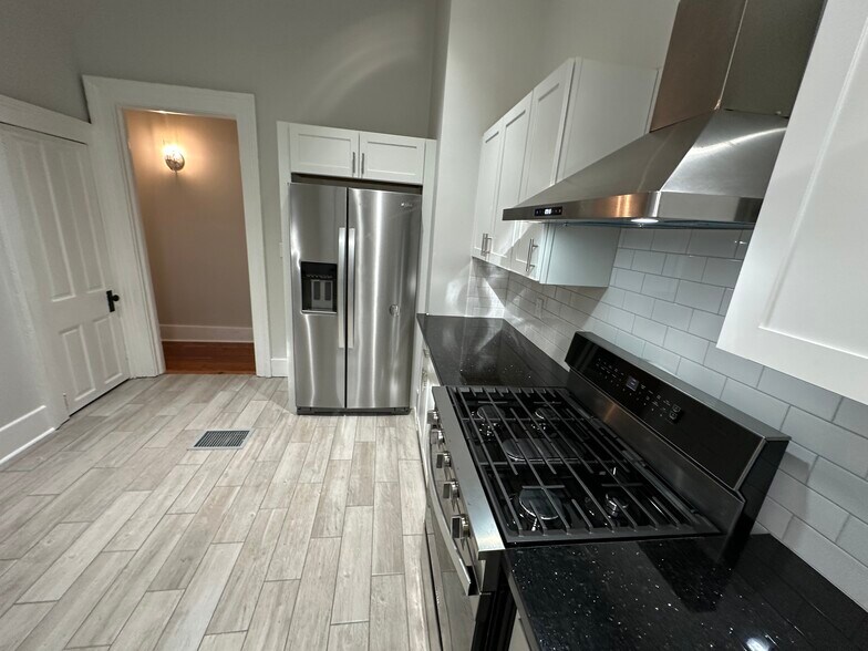 Fully renovated kitchen with granite countertops and all-new stainless steel appliances - 5520 Loyola Ave