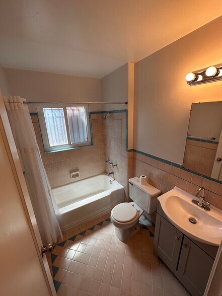 Bathroom refreshed with a new faucet and cabinet, repainted tub, and updated shower head - 6333 MacArthur Blvd