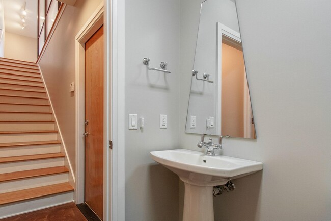 1/2 bathroom on bottom floor with door leading to the garage. - 300 Van Buren St