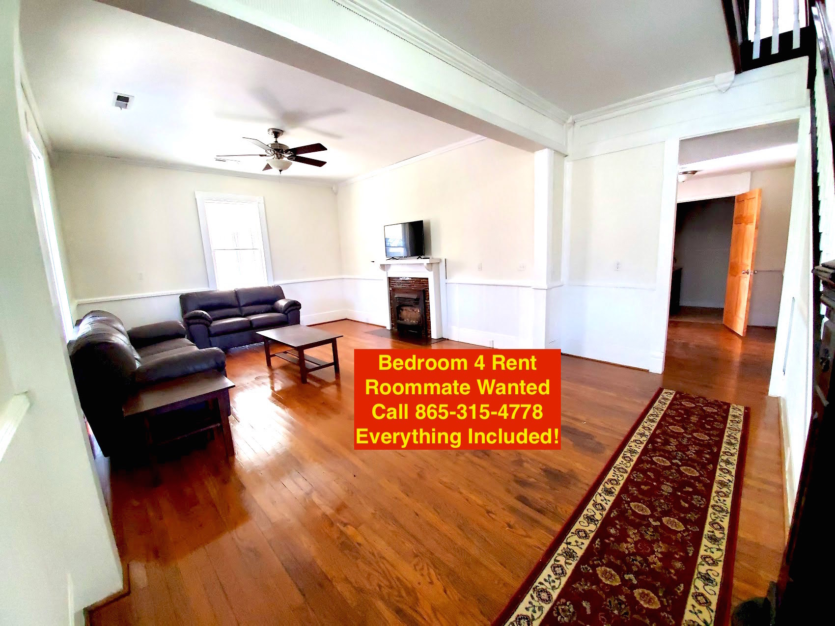 Beautiful large living room with oak wood floors and furnished with quality furniture and smart TV - 526 Monroe St