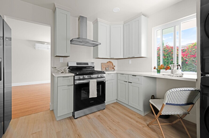 Quartz countertops, custom cabinetry, in unit laundry - 9211 Earl St
