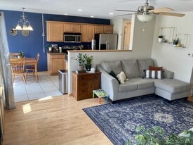 open-concept living, dining and kitchen - 906 SE Crossings Ln