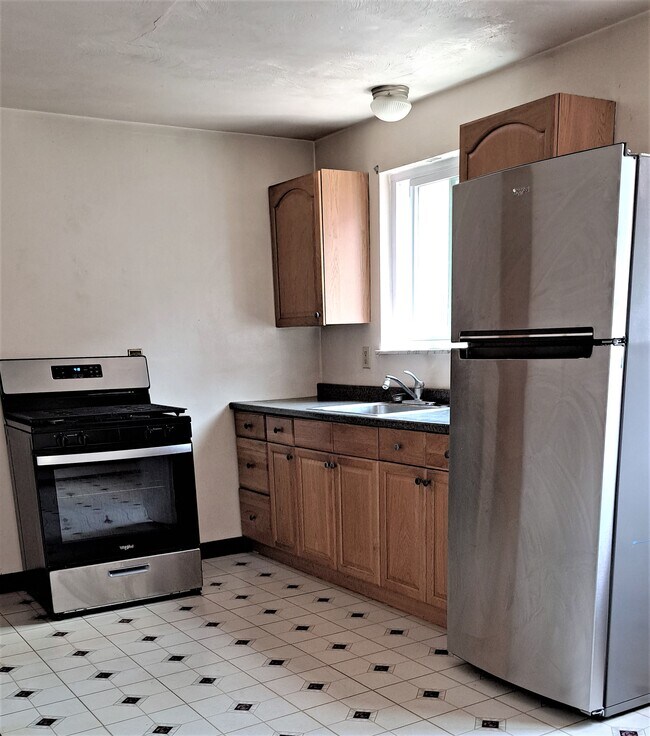 Kitchen with new stainless range and refrigerator - 402 Brierly Ln
