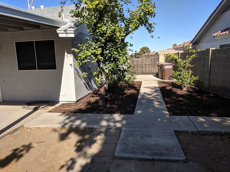 Facing West from back yard, looking at lemon tree and RV gate - 14101 N 78th Dr