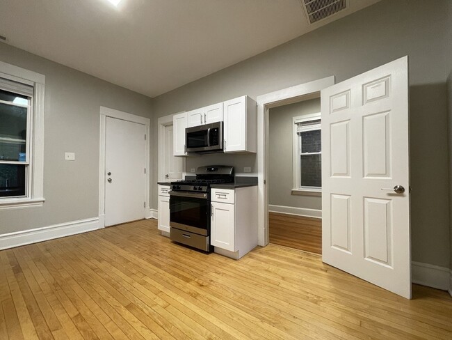 White cabinets and a built-in microwave - 1841 N Hermitage