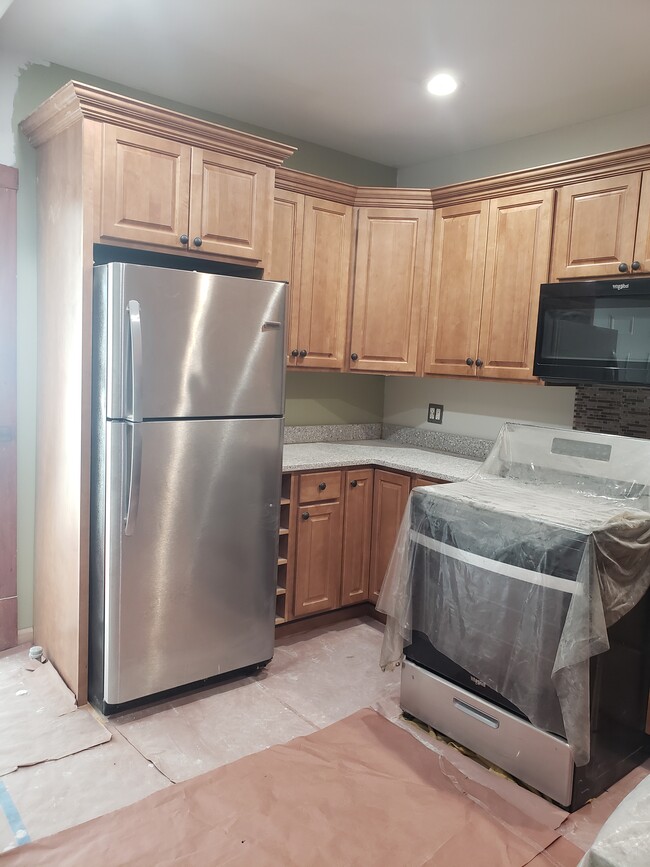 Kitchen newly remodeled with stove, refrigerator - 3811 N Central Park Ave