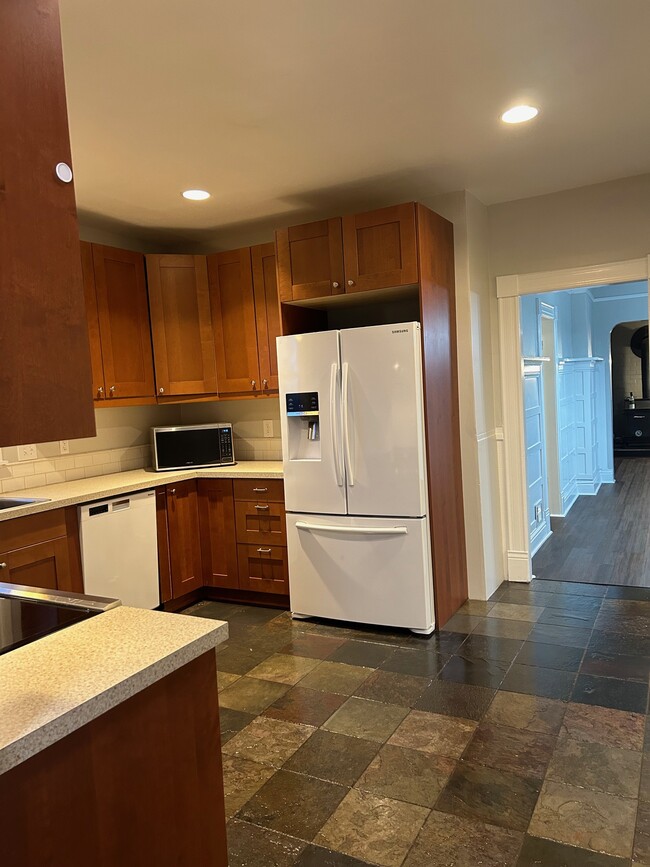 The kitchen also has a waste disposal, microwave, dishwasher, and refrigerator. - 3720 S L St