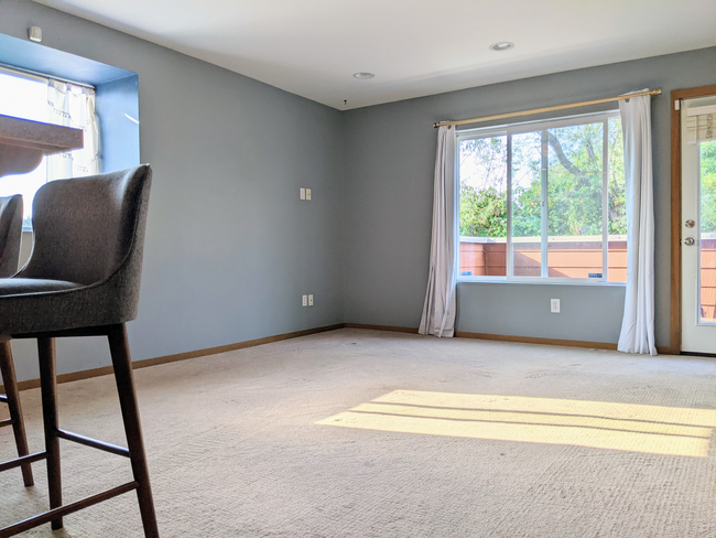 Open kitchen and living room with bar top area - 4810 S Holly St