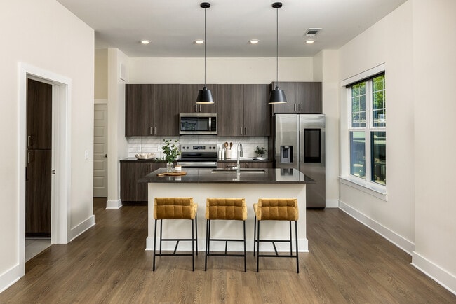 Gourmet kitchen with generous island and stainless smart refrigerator