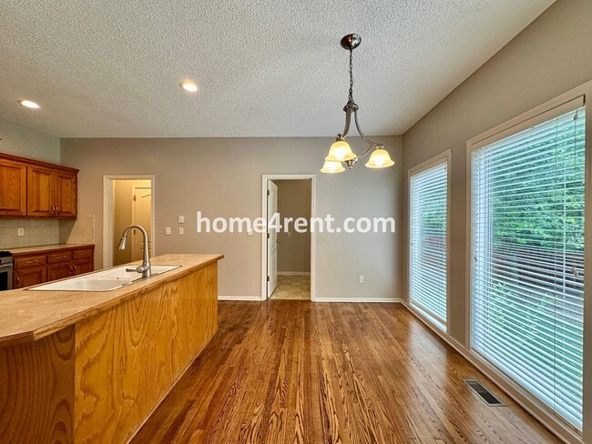 Building Photo - Beautiful Four-Bedroom Home with Three Car Garage, Wood Floors, Finished Basement and a Fenced Ya...