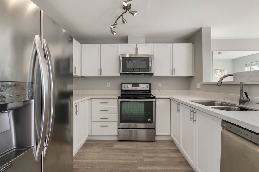 Kitchen with stainless steel appliances and quartz countertops - 9910 NE 137th St
