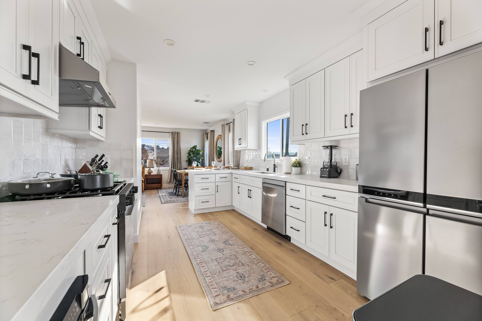 Chef's kitchen with natural sunlight and luxury appliances. - 1823 N Ditman Ave