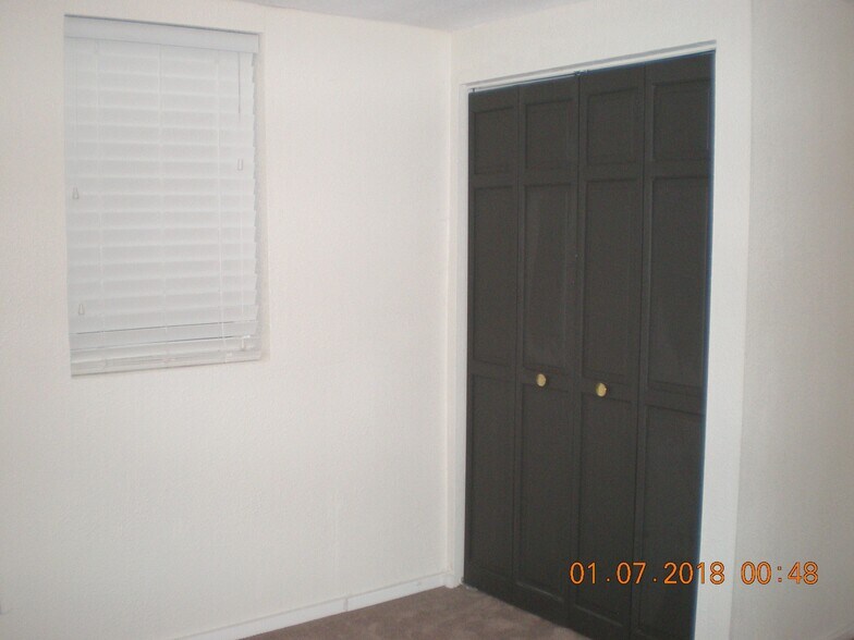 Second bedroom lower level, new carpet and paint and large east facing window for sun and safety exit. - 1160 Clinton St