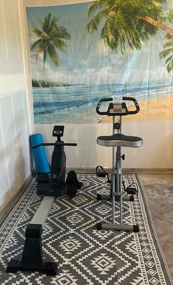Workout area in garage with a Stationary Bike, Rower, and Yoga Mat - 34558 Fry Rd SE