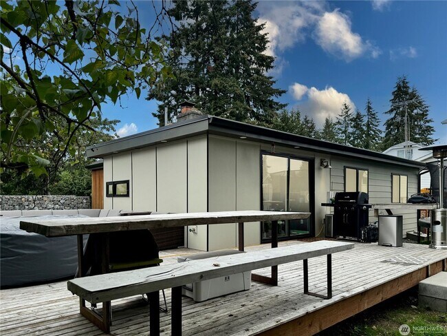 Building Photo - Remodeled 3 bdrm home on a large lot with 500 sq ft wrap around deck!