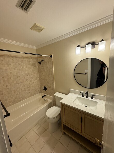 Bathroom 1 - all new tile surround, toilet, vanity, hardware and lighting - 406 Rosa Ave