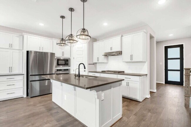 Building Photo - ASK ABOUT FREE APPLICATIONS THROUGH AUGUST!  "Spacious 4-Bedroom Sanctuary with Cozy Fireplace in...