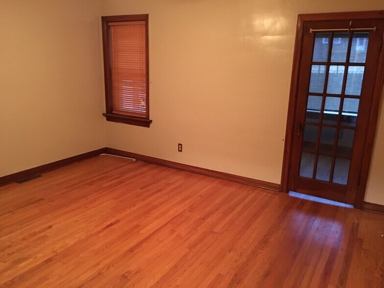 Bedroom 1. French door leads to Den / Sun Room. - 6000 Carlsbad Avenue