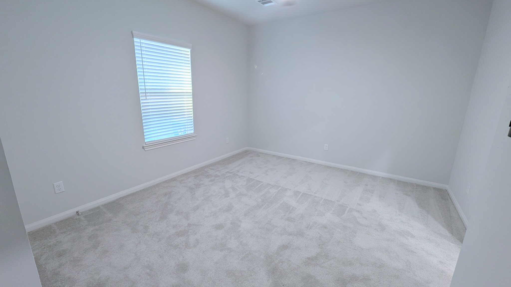 Primary bed easily fits a king bed and has ceiling fan and new carpeting. - 13218 HP Johnson St