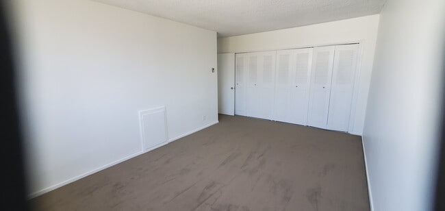bedroom with wall of closets - 252 S Reeves Dr