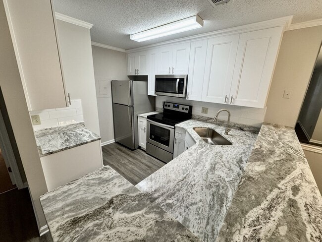 Building Photo - Updated 1st Floor/1-Level Condo Available NOW & Rent Includes Water, Sewer, Trash, Landscaping, F...