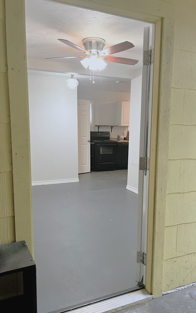 Front door enters into living area with kitchen in the back - 1127 Walling St