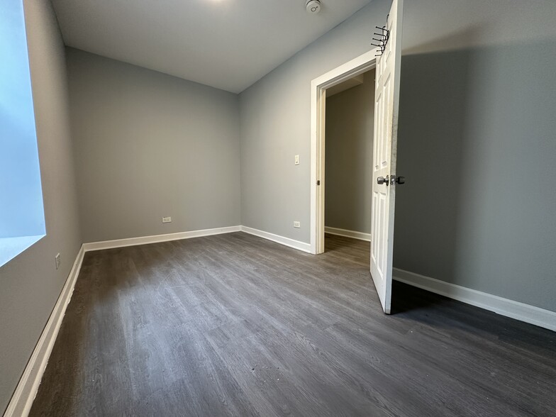 Large bedroom with new flooring opening onto the hallway - 5653 S May St