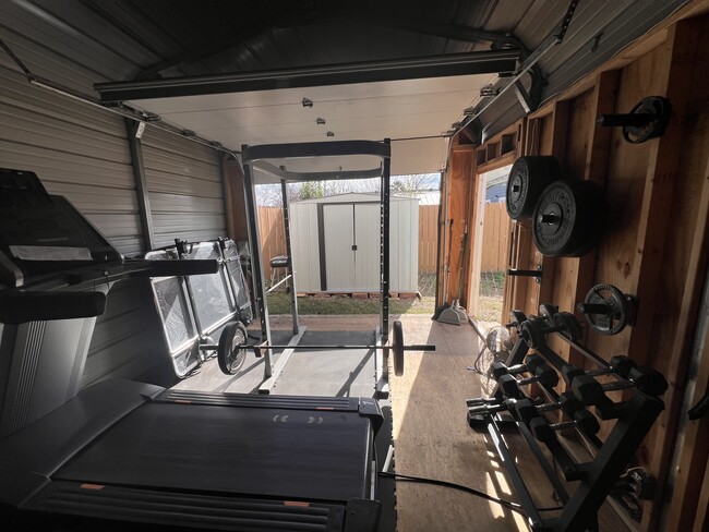 Squat rack, barbell, treadmill, bumper plates and dumbbells. - 422 S Olive St