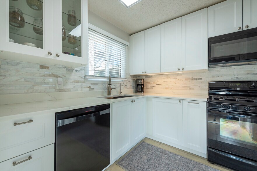 Chef's kitchen with deep sink, modern fixtures with under cabinet lighting. - 405 Windswept Dr