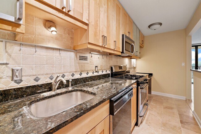 Building Photo - Spacious, and Sunlit 1 BD/1 BA Condo w/Reserved Garage Parking and Utilities Included in Chevy Ch...