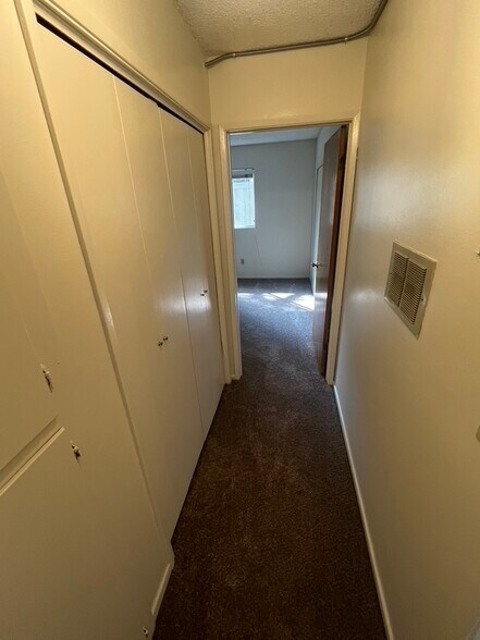 hallway with laundry area and cupboards on left - 3262 Montrose Ave
