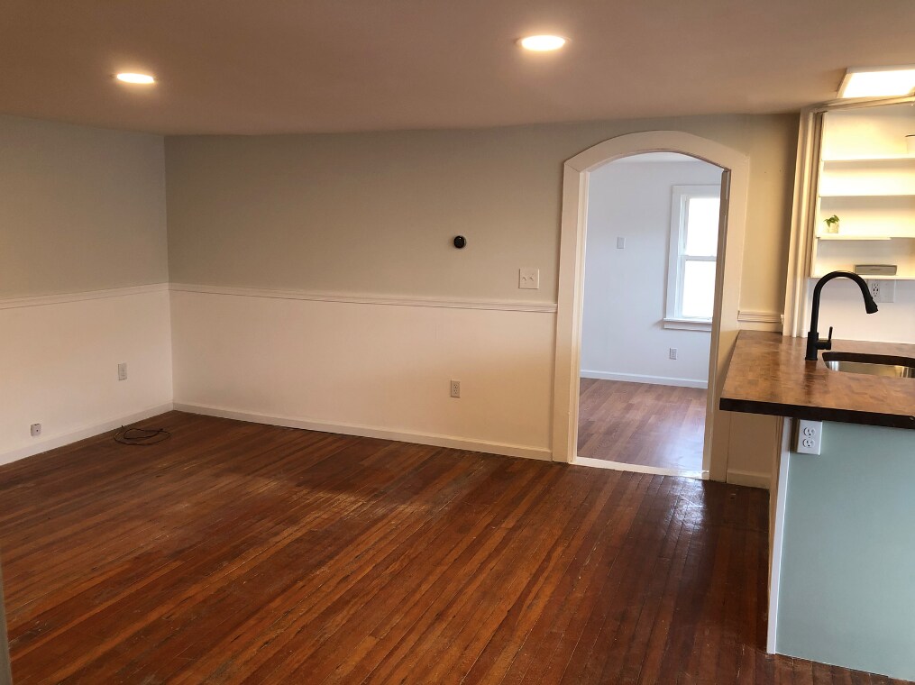 main room: next to kitchen, entry to lower bedroom, full bathroom and stairs. - 11 Waterside Ln