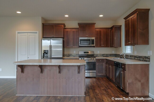 Building Photo - Spacious 4-Bedroom + Office Home in Abbey Creek – Modern Finishes, EV Charger & Low-Maintenance B...