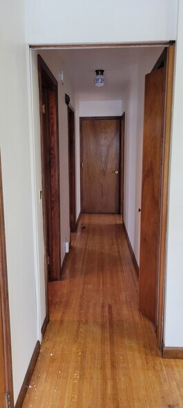 Hallway from kitchen, first left is bathroom and second left bedroom, end of hall to right is living - 481 Meigs St