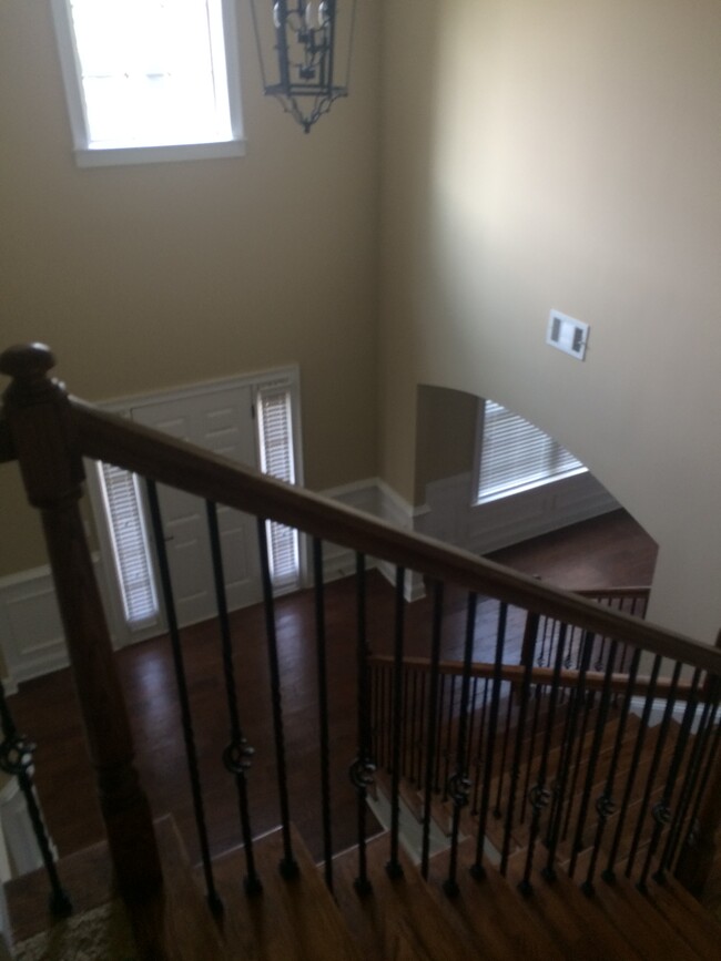 View from upstairs looking down to front door and formal dining room - 319 Haywood Dr