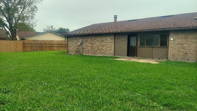 The Rear of the House has a Patio Pad and Access Through a Security Door to an Oversized Back Yard. - 5538 W Ridgecreek Dr