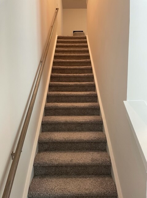 Stairway leading upstairs in identical townhome - 866 Longleaf Ln